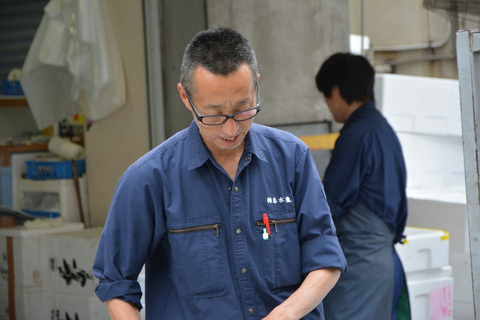 man in blue polo shirt wearing black framed eyeglasses